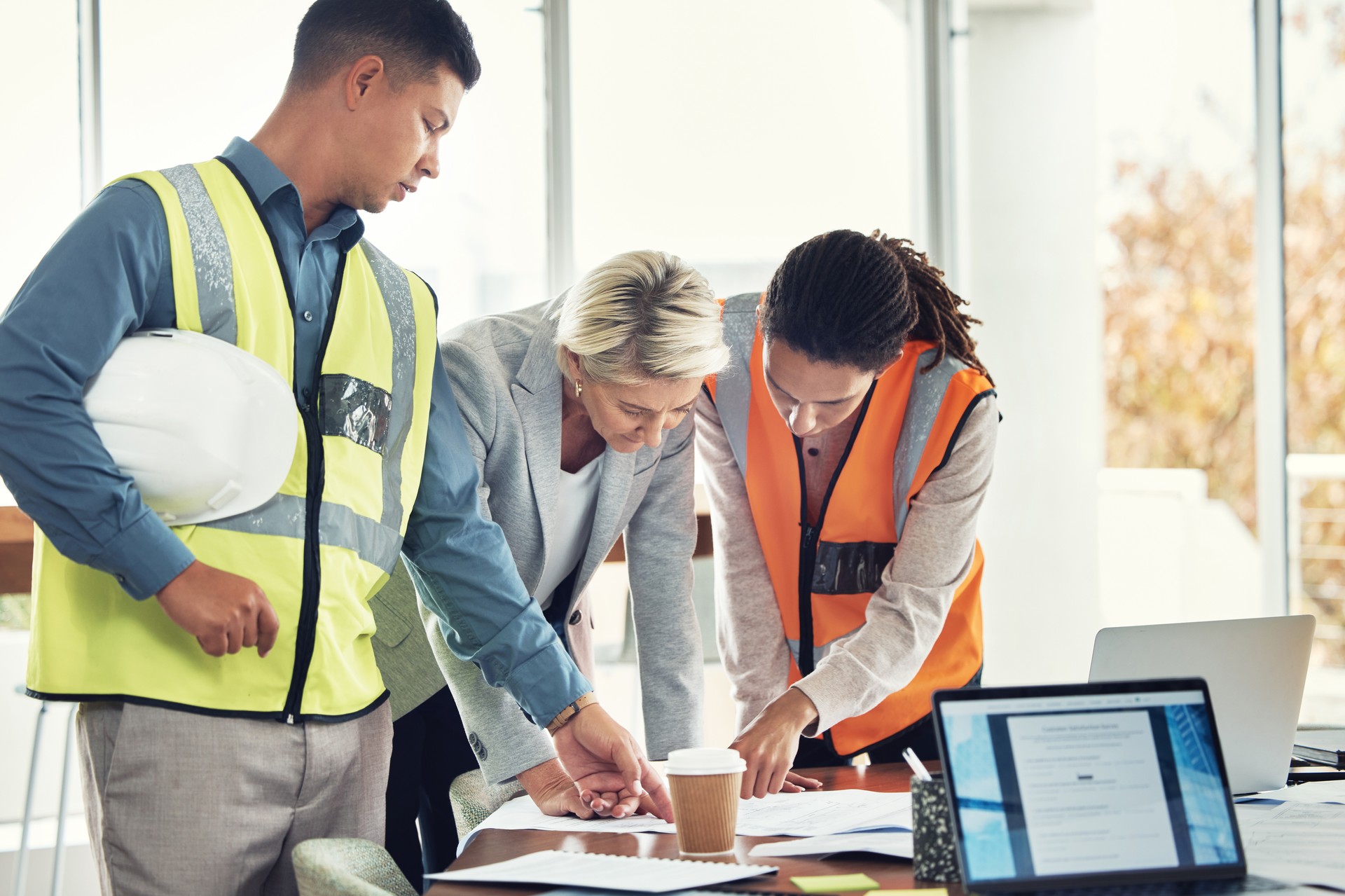 Engineering, teamwork and meeting with people in office for construction, designer and building. Collaboration, review and planning with group in architecture firm for project management and goal